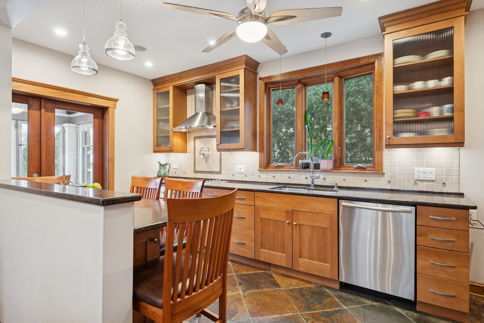 369 Addison Road Riverside, IL 60546 - Photo 8 of 23 a dining hall with stainless steel appliances granite countertop a stove and a sink with dishwasher next to a window
