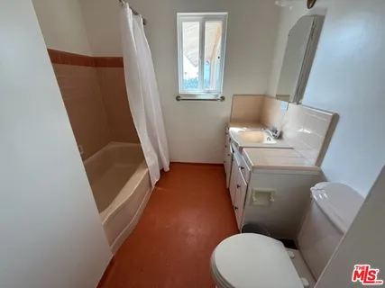 a bathroom with a toilet and a sink