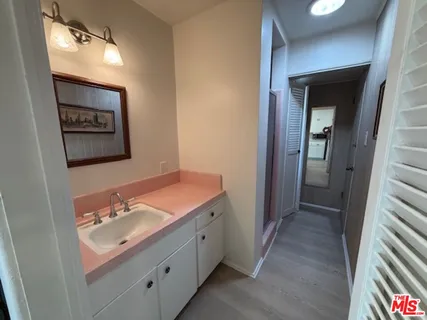 a bathroom with a sink a mirror and a toilet