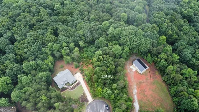an aerial view of a house with yard and outdoor seating