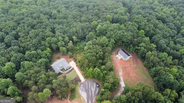 an aerial view of house with yard and outdoor seating