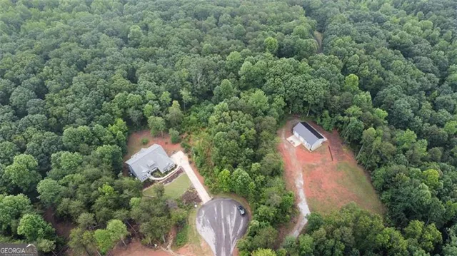 an aerial view of house with yard and outdoor seating