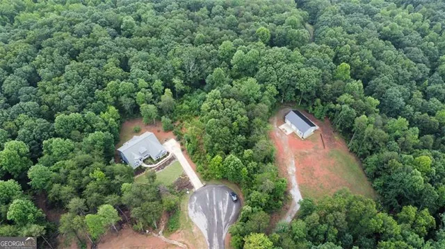 an aerial view of house with yard and outdoor seating