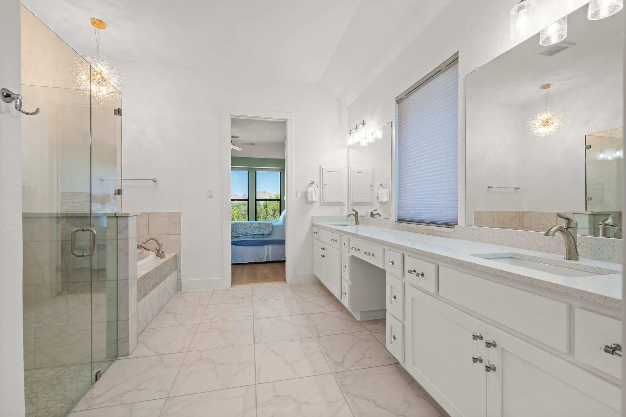 7804 Pace Ravine Drive Lago Vista, TX 78645 - Photo 15 of 34 a spacious bathroom with a granite countertop sink mirror and shower