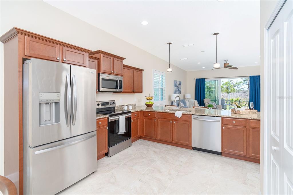 8952 Scallop Way Placida, FL 33946 - Photo 13 of 52 a kitchen with granite countertop stainless steel appliances and refrigerator