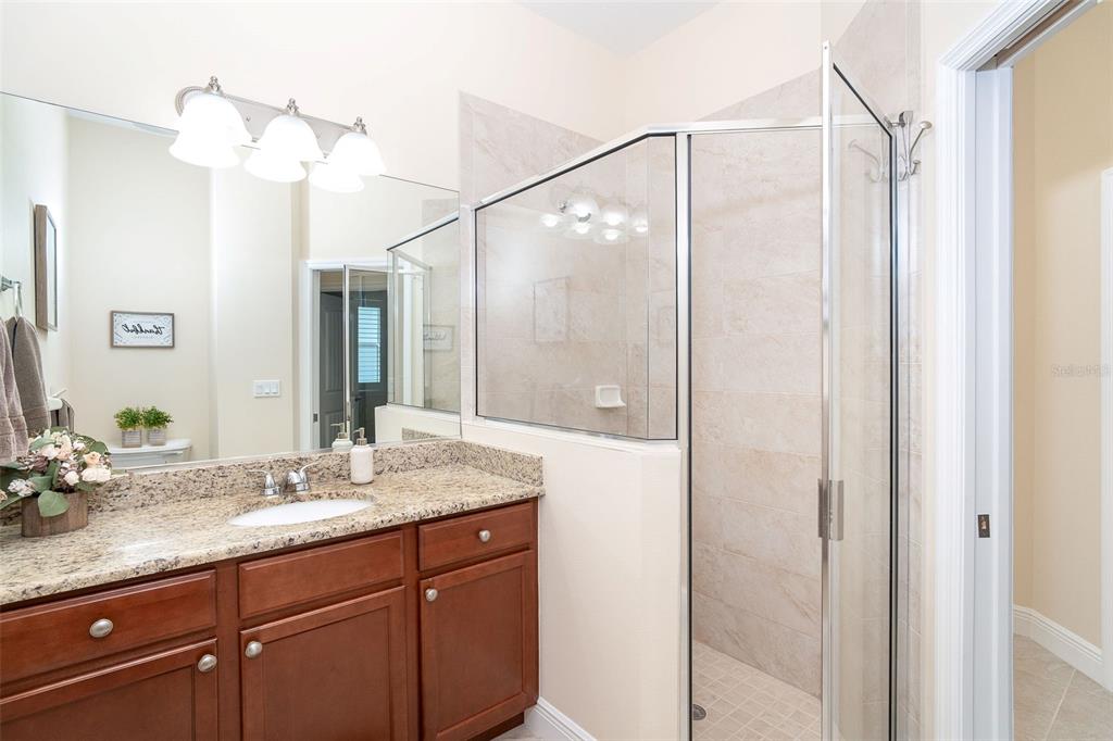 8952 Scallop Way Placida, FL 33946 - Photo 38 of 52 a bathroom with a granite countertop shower sink and mirror