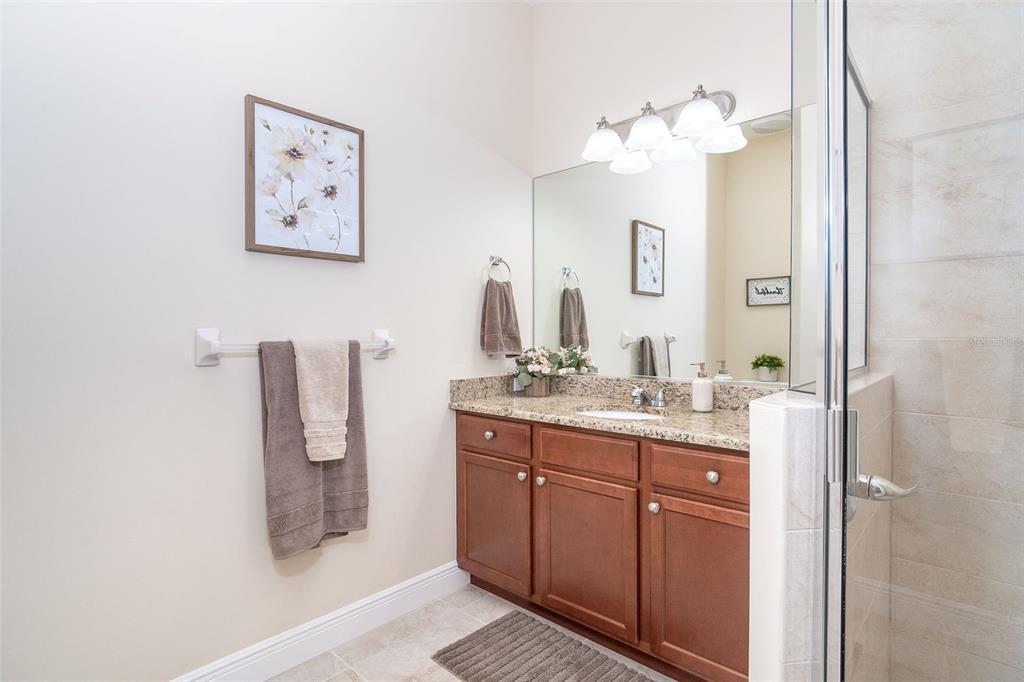 8952 Scallop Way Placida, FL 33946 - Photo 39 of 52 a bathroom with a granite countertop sink a mirror and a shower