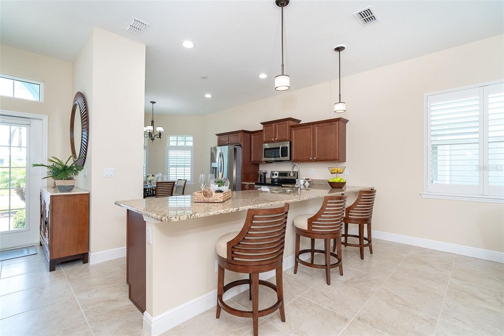8952 Scallop Way Placida, FL 33946 - Photo 7 of 52 a view of a dining room and livingroom with furniture wooden floor a chandelier