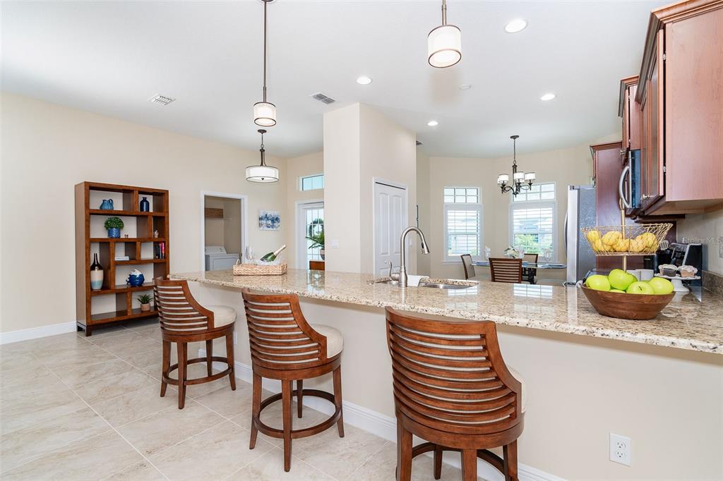 8952 Scallop Way Placida, FL 33946 - Photo 8 of 52 a kitchen with sink and chairs