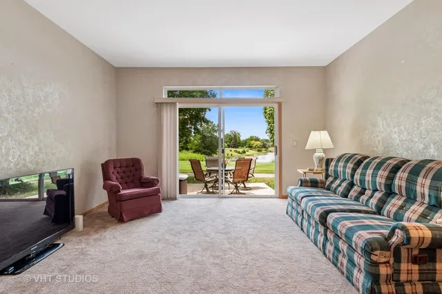 a bed sitting in a spacious bedroom next to a window
