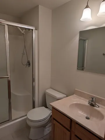 a view of a lake with a table and chairs in the patio