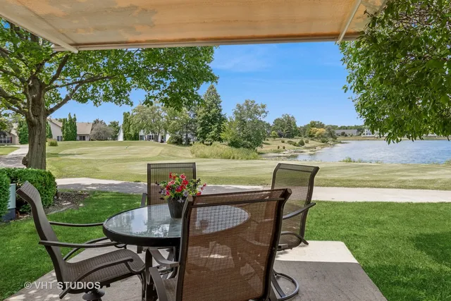 a view of backyard of house with outdoor seating and green space