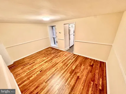 a view of a room with wooden floor