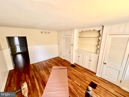 a bedroom with a bed and a mirror on the wall