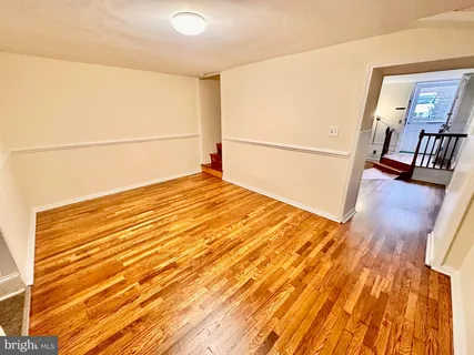 a view of a room with wooden floor