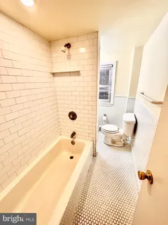 a bathroom with a bathtub and shower
