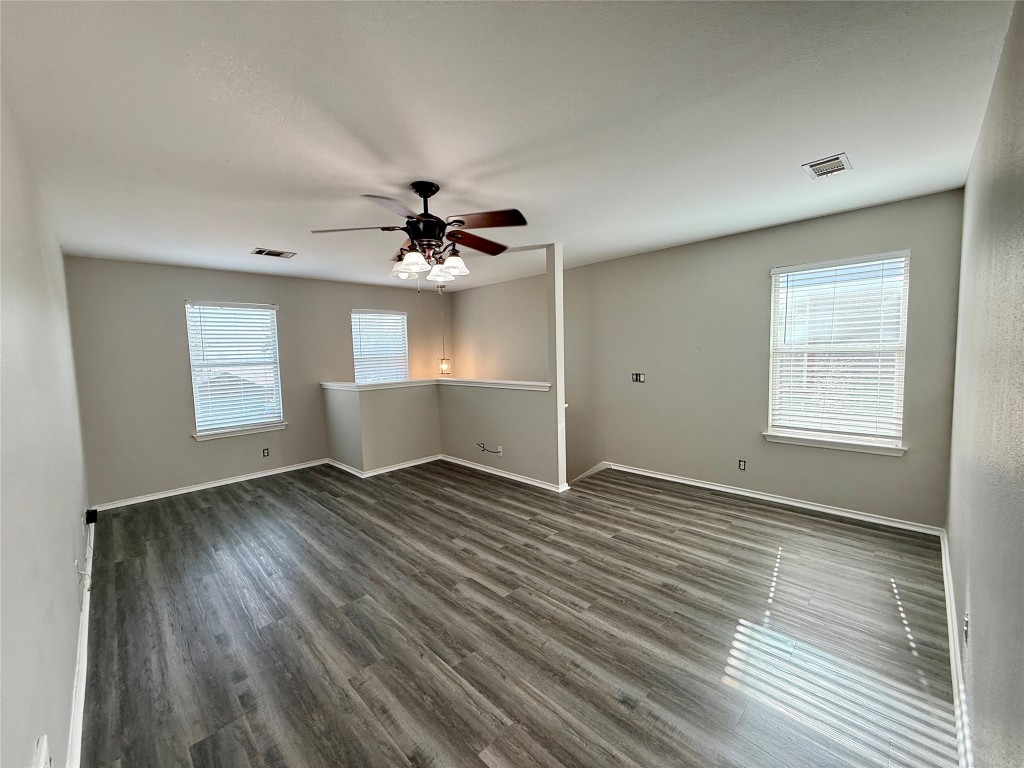 17212 Hamilton Point Circle Manor, TX 78653 - Photo 12 of 27 an empty room with wooden floor and windows