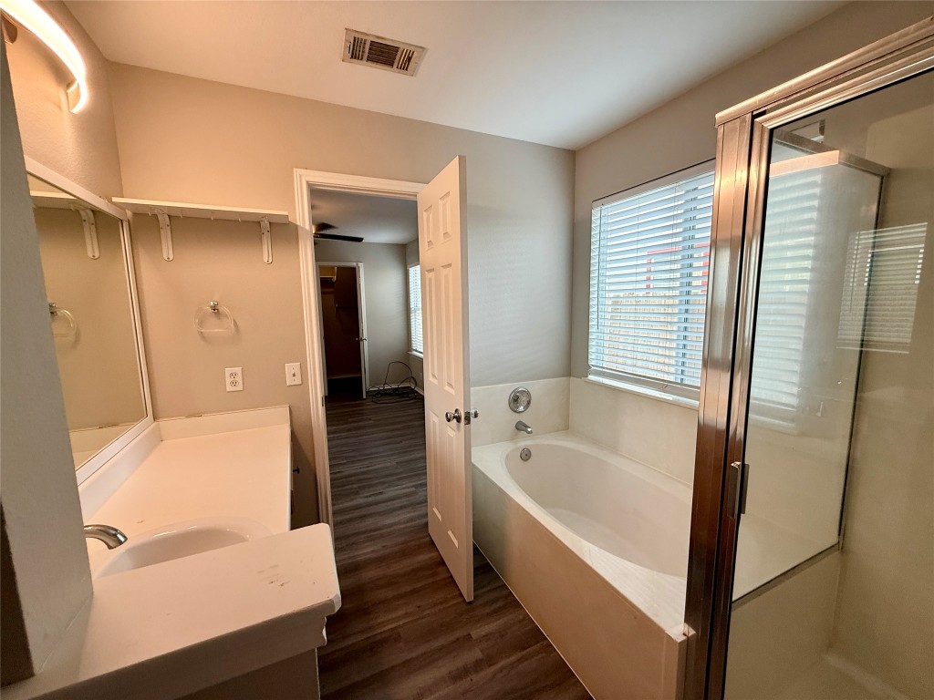 17212 Hamilton Point Circle Manor, TX 78653 - Photo 17 of 27 a bathroom with a bathtub and a shower