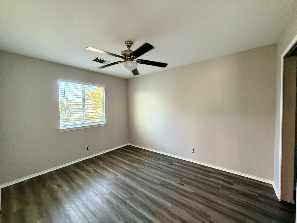 17212 Hamilton Point Circle Manor, TX 78653 - Photo 19 of 27 a view of a room with wooden floor and a window