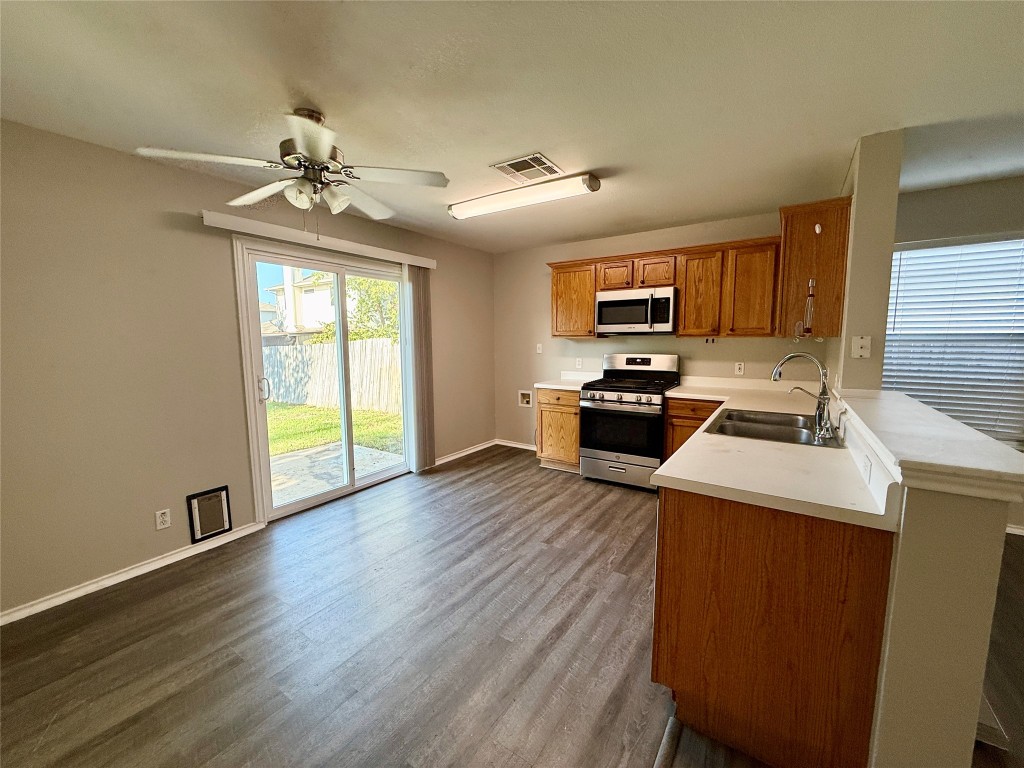 17212 Hamilton Point Circle Manor, TX 78653 - Photo 3 of 27 a kitchen view with wooden floor and stainless steel appliances