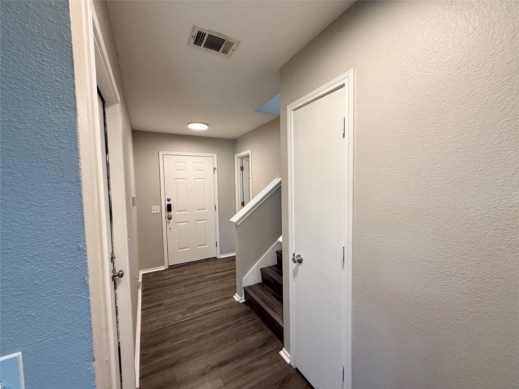 17212 Hamilton Point Circle Manor, TX 78653 - Photo 9 of 27 a view of hallway with stairs and wooden floor