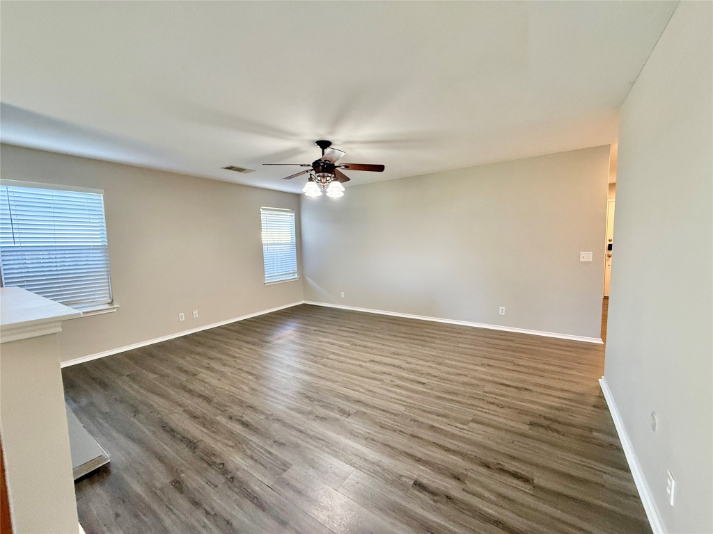 17212 Hamilton Point Circle Manor, TX 78653 - Photo 10 of 27 a view of an empty room with wooden floor