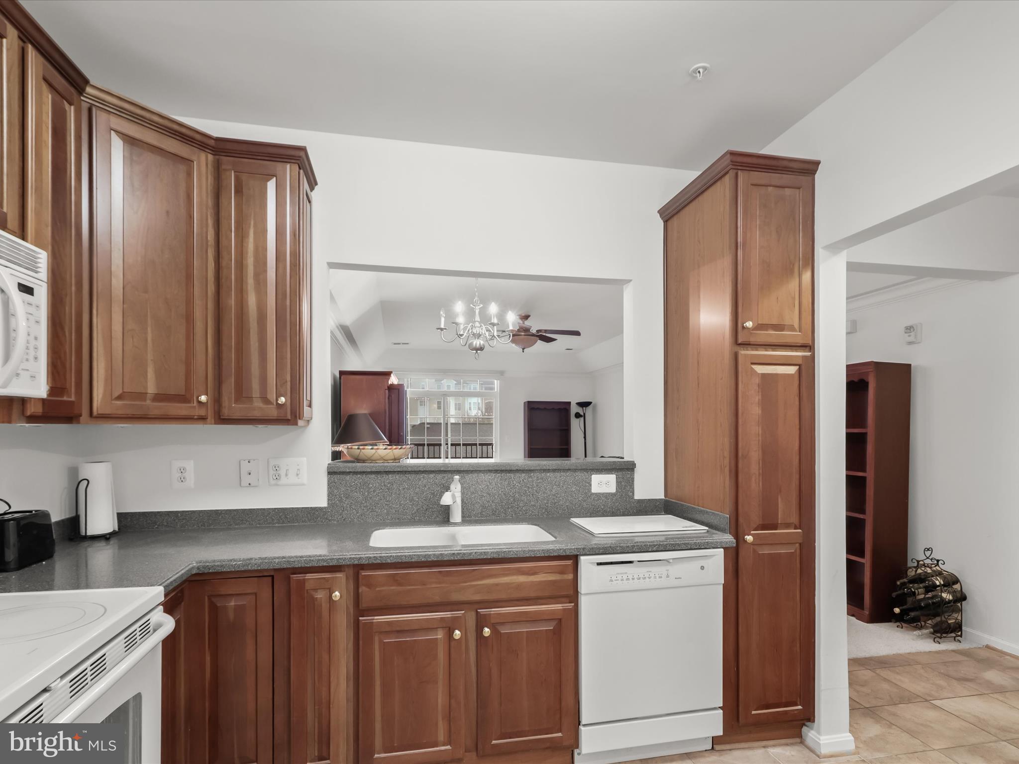 7325 Brookview Road, Unit 208 Elkridge, MD 21075 - Photo 11 of 31 a kitchen with a sink stove and refrigerator