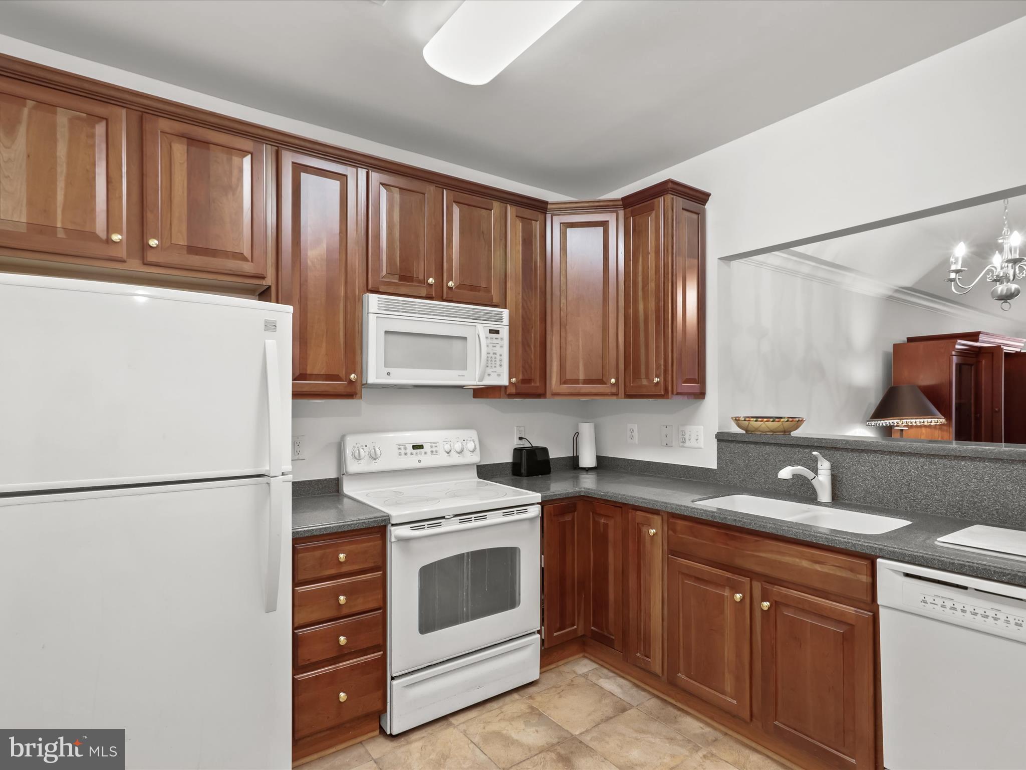 7325 Brookview Road, Unit 208 Elkridge, MD 21075 - Photo 12 of 31 a kitchen with a white stove top oven and refrigerator