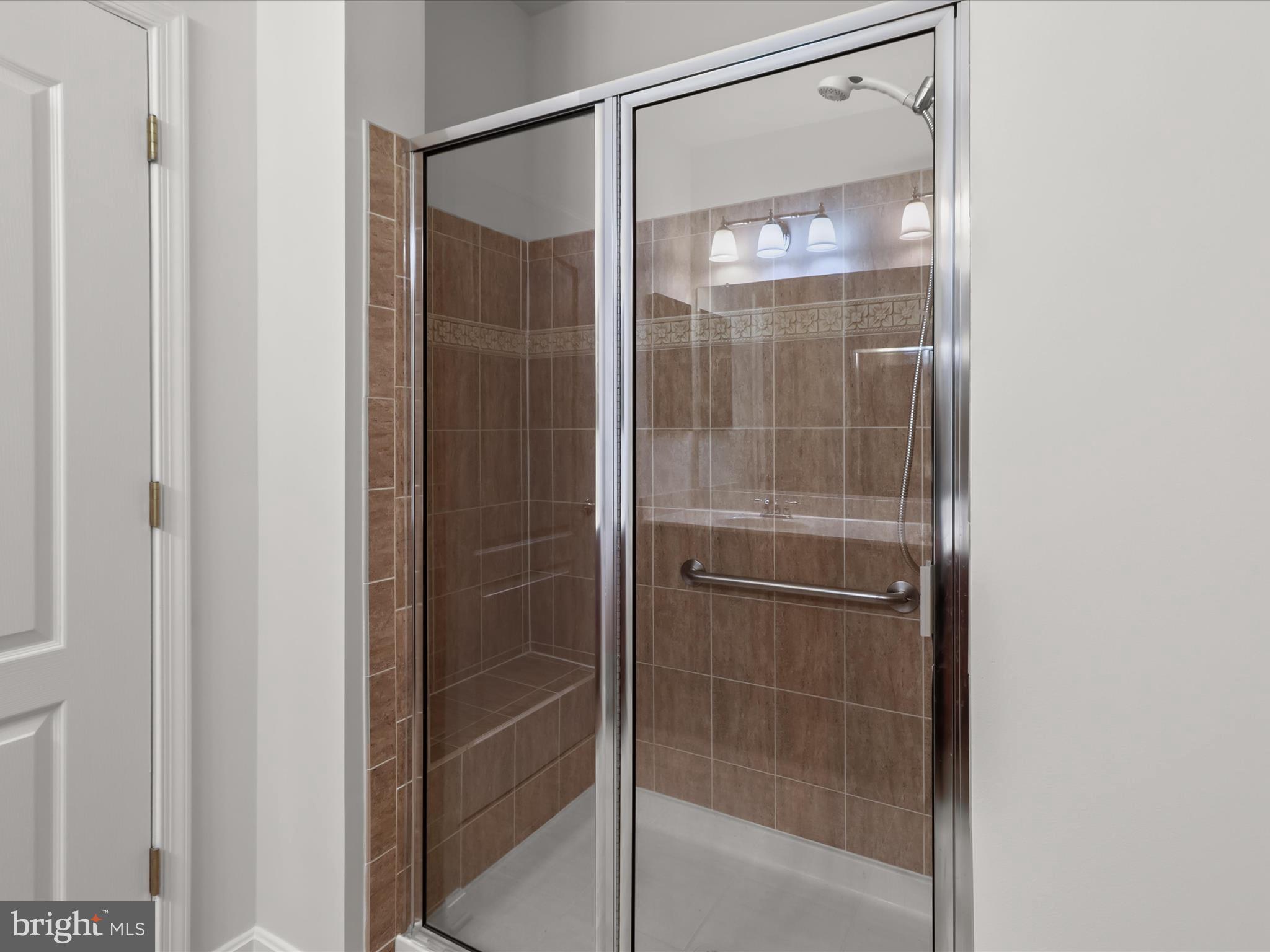 7325 Brookview Road, Unit 208 Elkridge, MD 21075 - Photo 21 of 31 a bathroom with a glass shower door