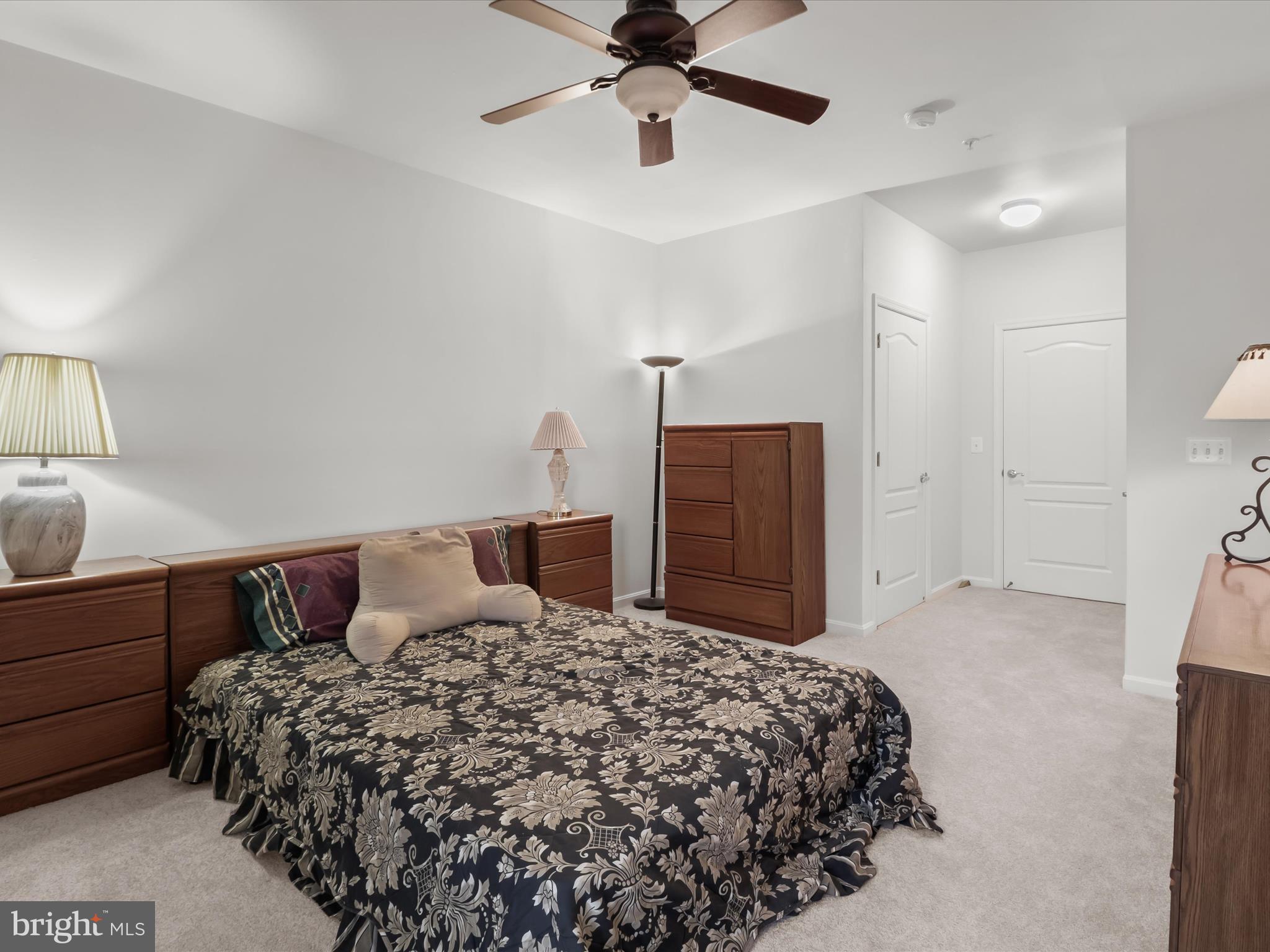 7325 Brookview Road, Unit 208 Elkridge, MD 21075 - Photo 22 of 31 a bedroom with a large bed and ceiling fan
