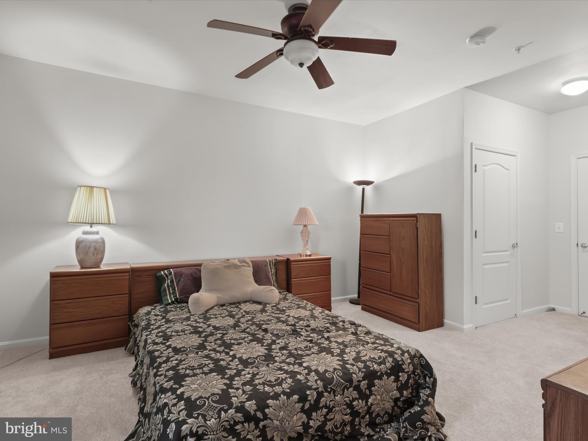 7325 Brookview Road, Unit 208 Elkridge, MD 21075 - Photo 23 of 31 a bedroom with a bed and a dresser
