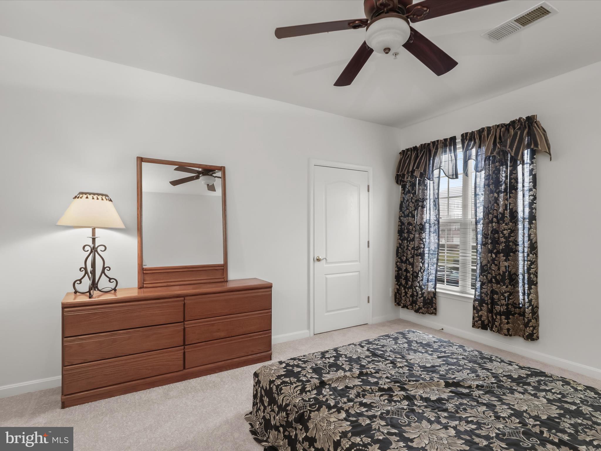 7325 Brookview Road, Unit 208 Elkridge, MD 21075 - Photo 25 of 31 a bedroom with a bed and a chandelier