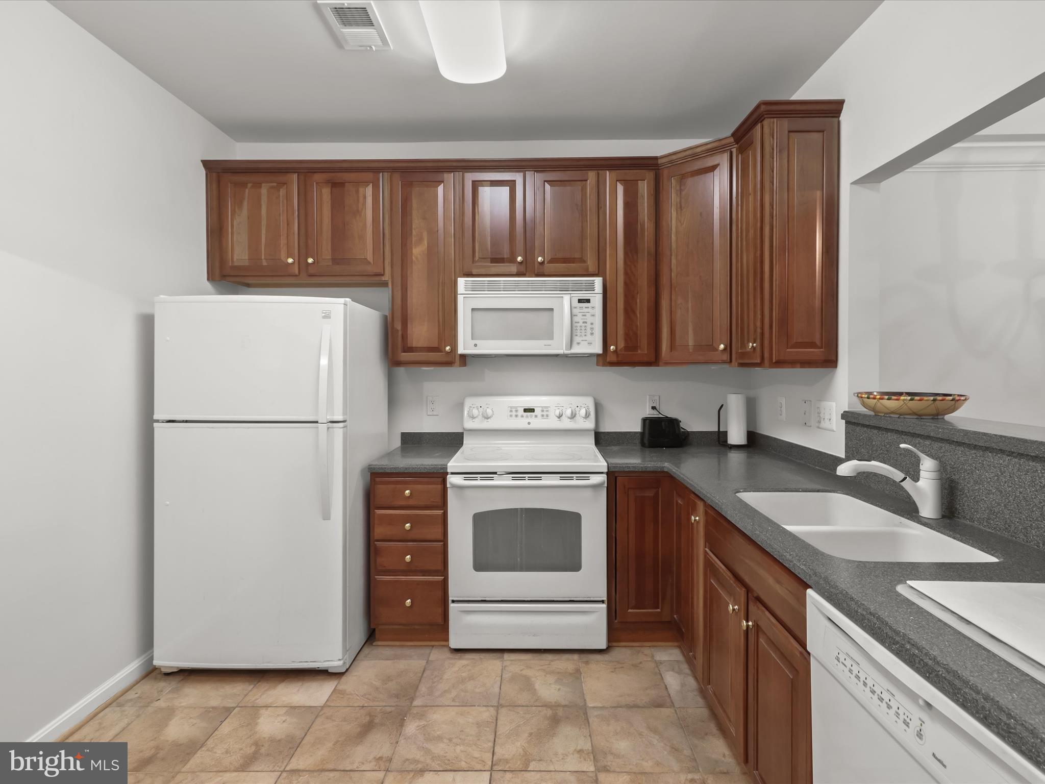 7325 Brookview Road, Unit 208 Elkridge, MD 21075 - Photo 10 of 31 a kitchen with a stove sink and refrigerator
