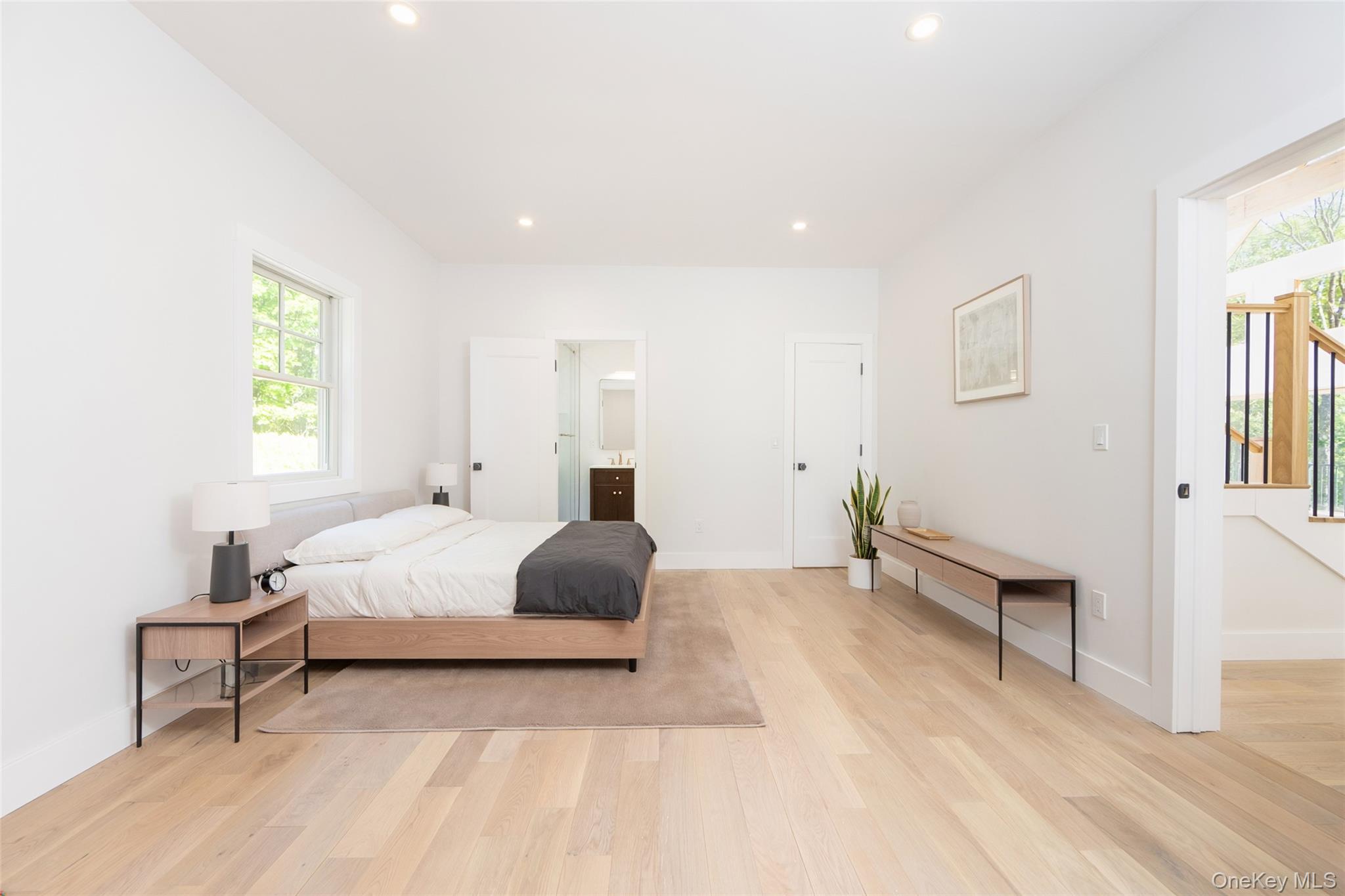 91 Lenni Lenape Road Narrowsburg, NY 12764 - Photo 13 of 25 Bright bedroom featuring light wood-finish flooring, recessed lighting, and a window with exterior viewsImages have been virtually staged to illustrate the property's potential