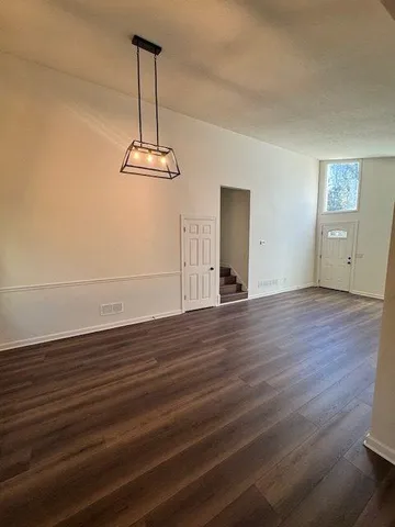 a view of a room with wooden floor window and a ceiling fan