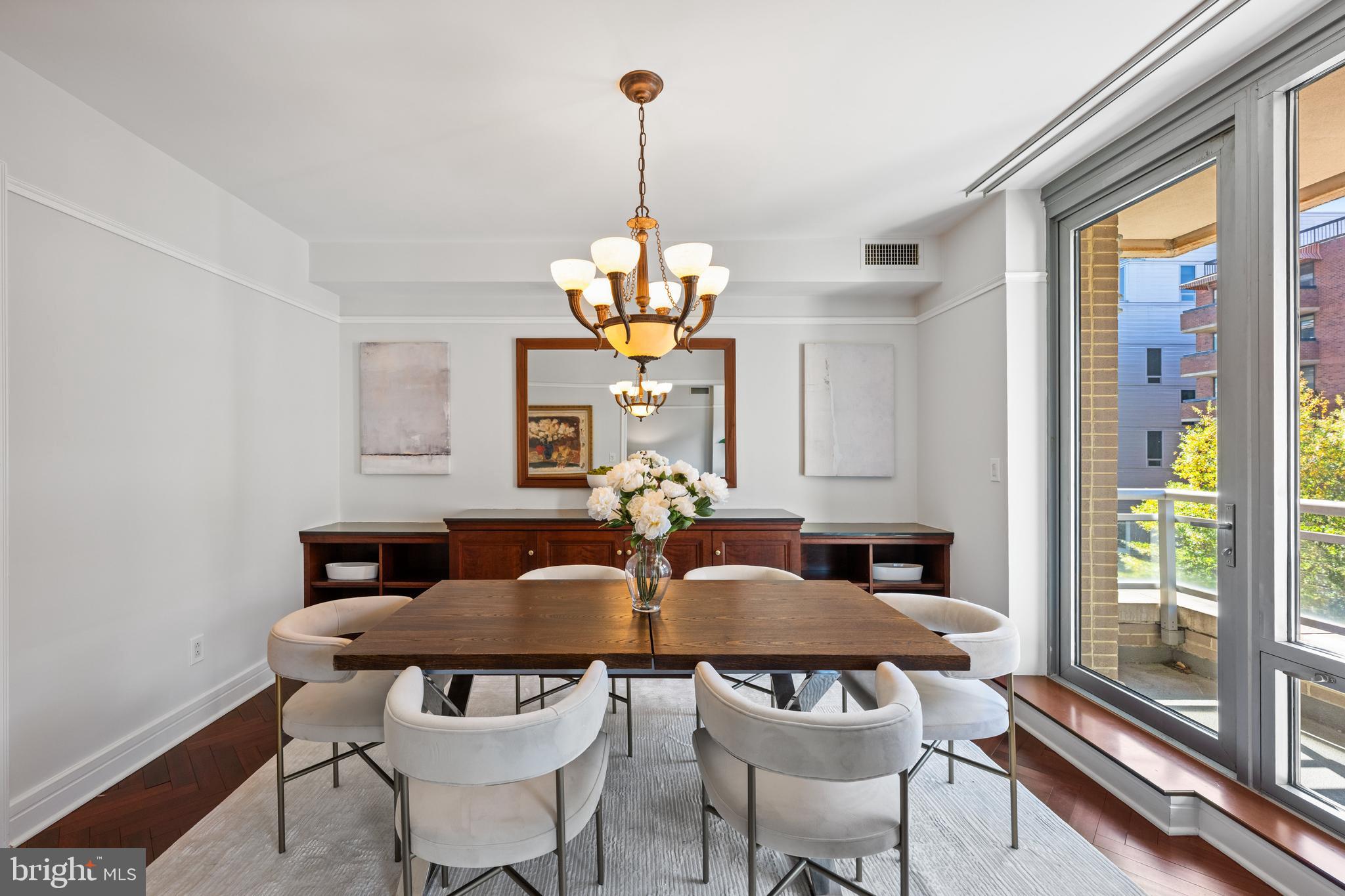 1155 23rd Street Northwest, Unit 6C Washington, DC 20037 - Photo 11 of 32 a view of a dining room with furniture wooden floor and chandelier