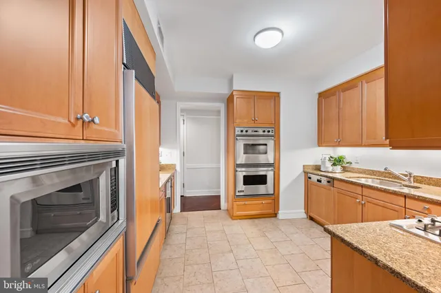 a kitchen with stainless steel appliances granite countertop a stove and a sink