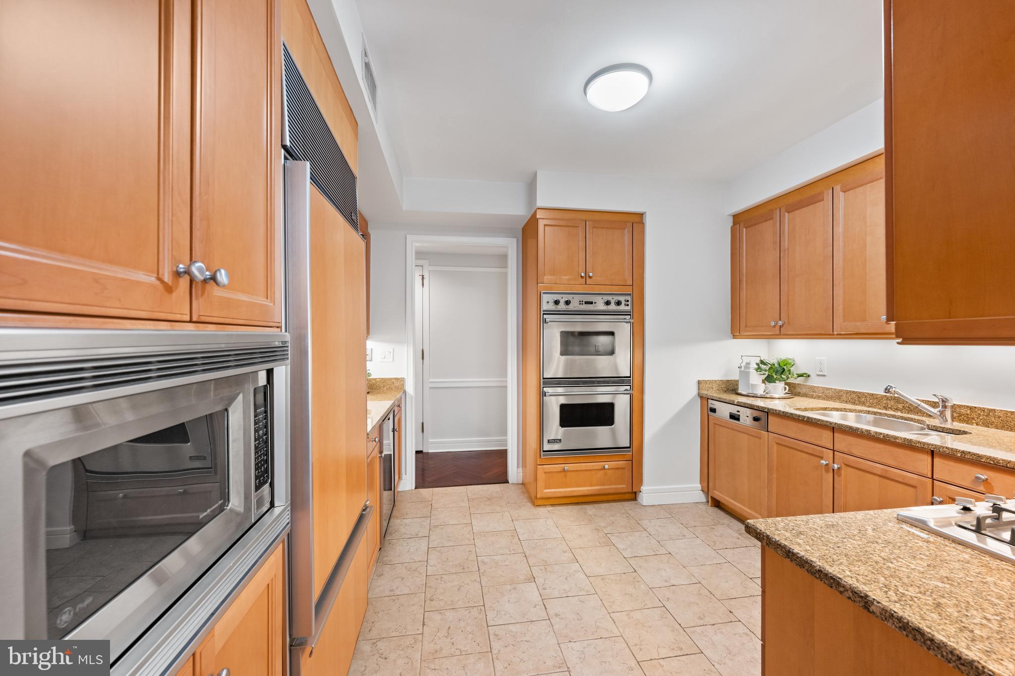 1155 23rd Street Northwest, Unit 6C Washington, DC 20037 - Photo 14 of 32 a kitchen with stainless steel appliances granite countertop a stove and a sink