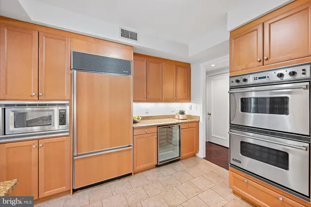 a kitchen with granite countertop cabinets stainless steel appliances and sink