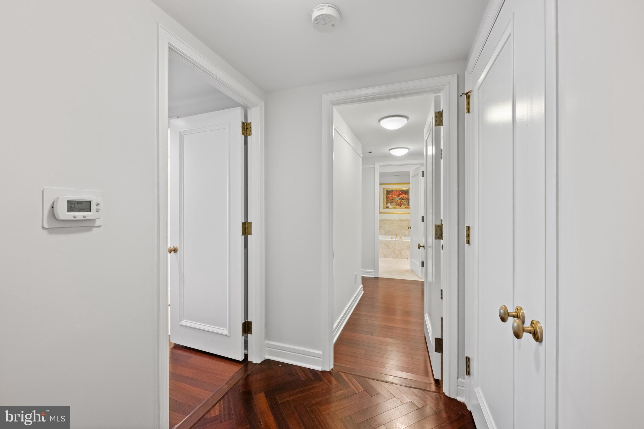 1155 23rd Street Northwest, Unit 6C Washington, DC 20037 - Photo 18 of 32 a view of a hallway with wooden floor and closet area