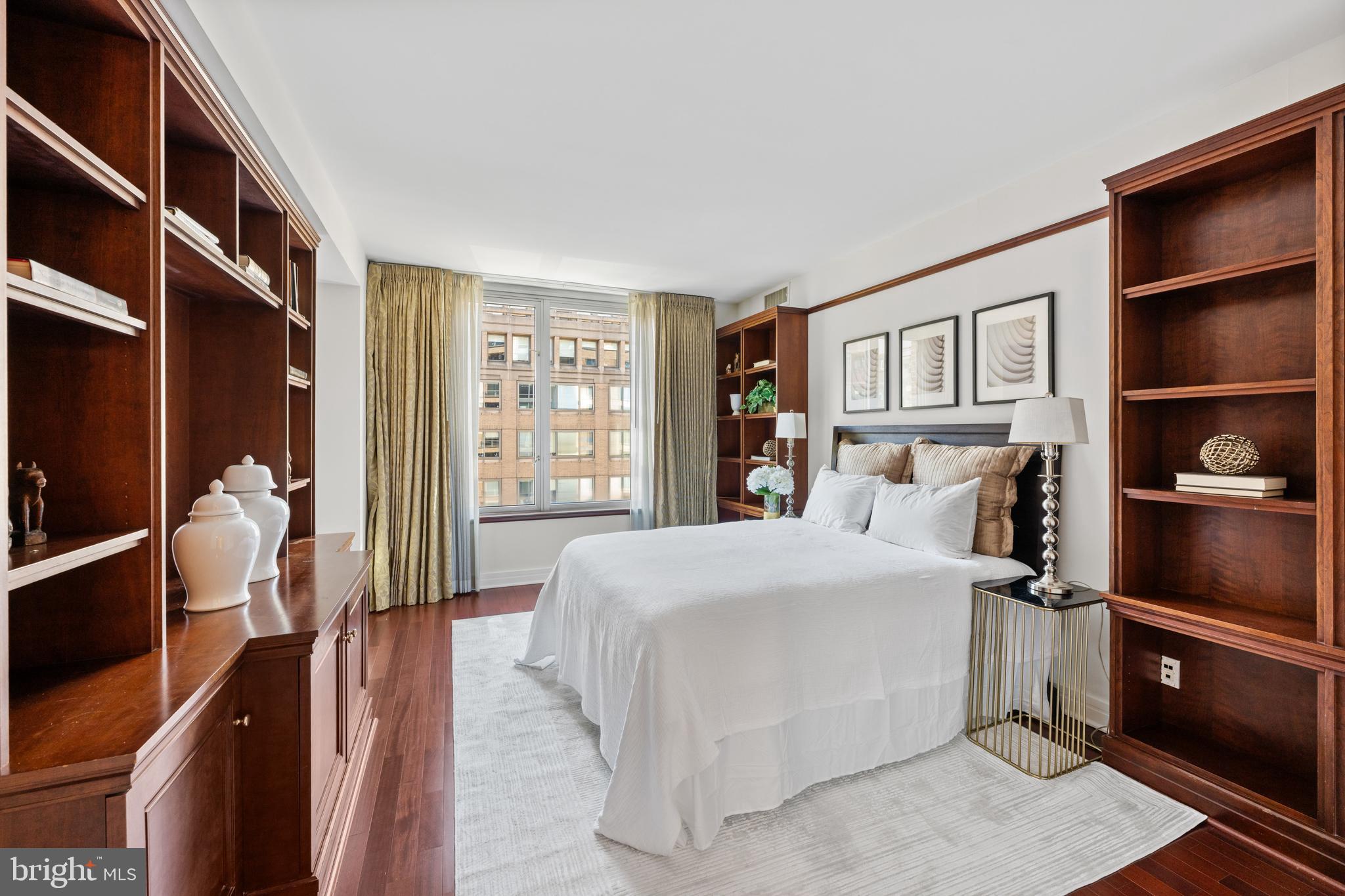 1155 23rd Street Northwest, Unit 6C Washington, DC 20037 - Photo 27 of 32 a bedroom with a bed and walk in closet