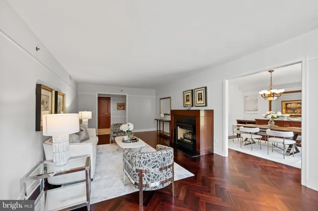 a living room with furniture a fireplace and a table