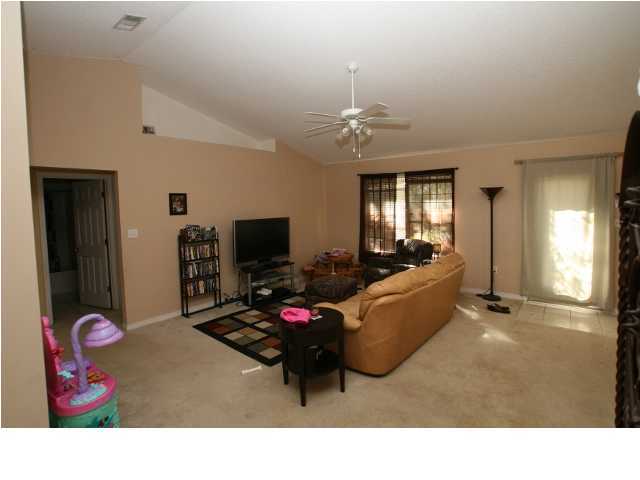 274 Beacon Way Miramar Beach, FL 32550 - Photo 2 of 8 a living room with furniture and a flat screen tv