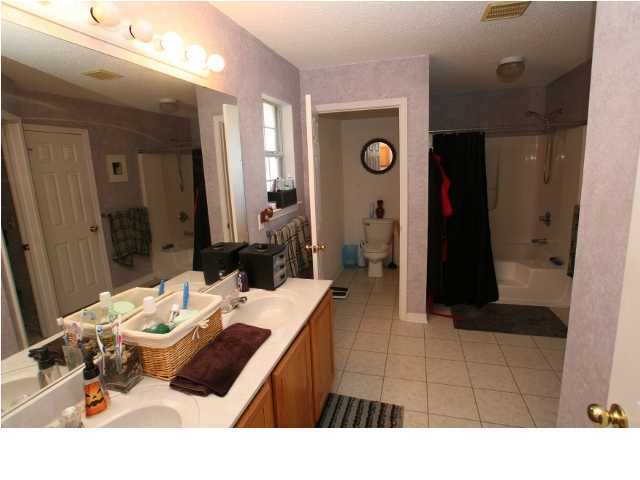 274 Beacon Way Miramar Beach, FL 32550 - Photo 6 of 8 a bathroom with a sink a mirror and shower