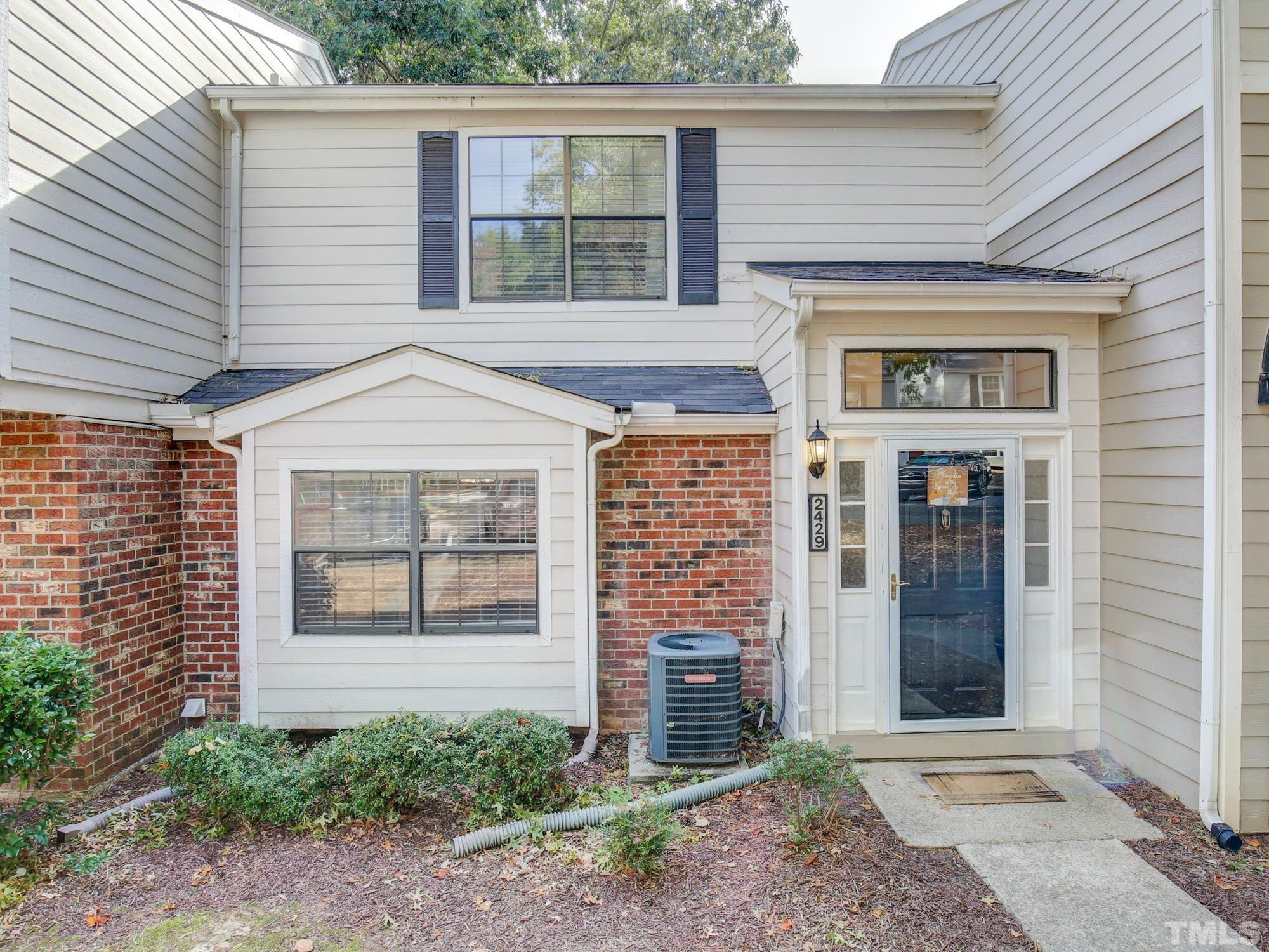 2429 Condor Court, Unit 2429 Raleigh, NC 27615 - Photo 1 of 26 a front view of a house with a yard
