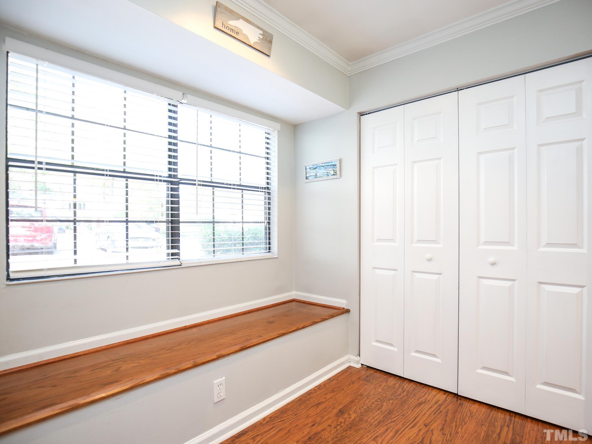 2429 Condor Court, Unit 2429 Raleigh, NC 27615 - Photo 11 of 26 an empty room with wooden floor and windows