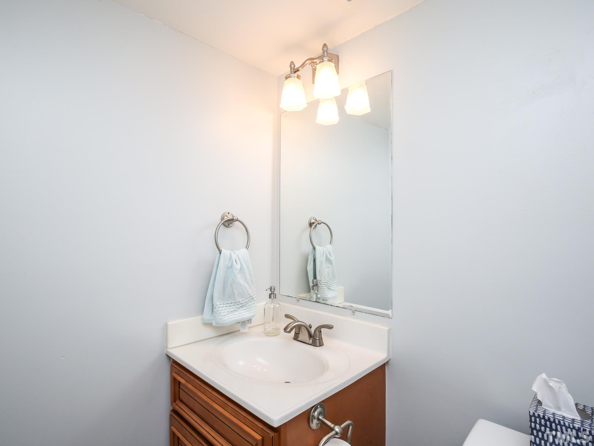 2429 Condor Court, Unit 2429 Raleigh, NC 27615 - Photo 13 of 26 a bathroom with a sink and a mirror