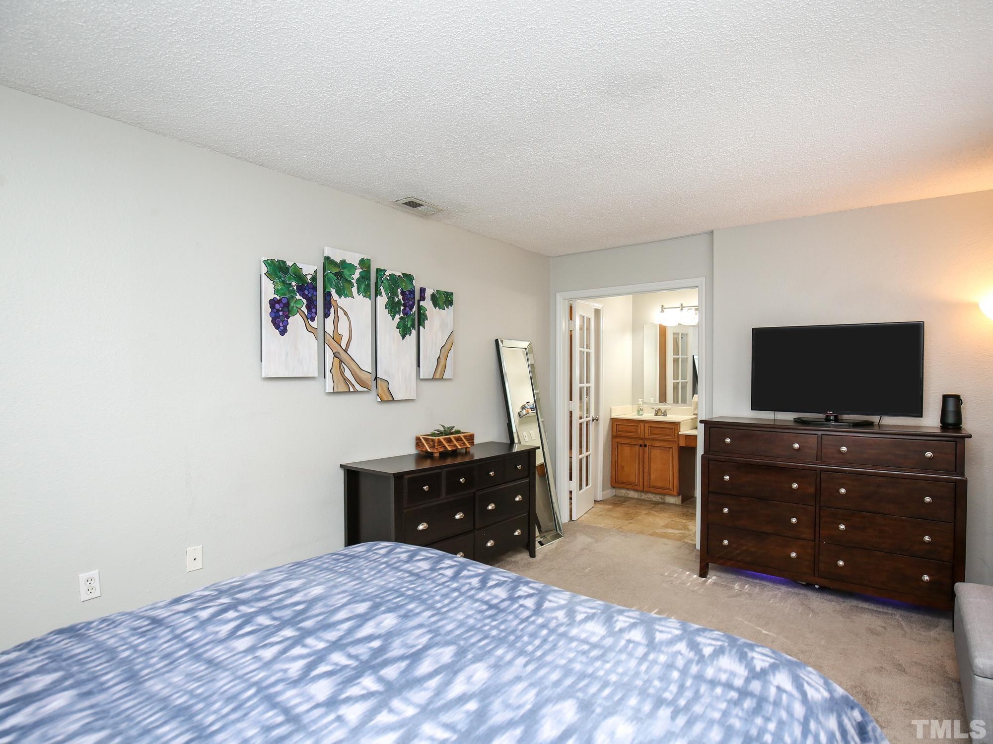 2429 Condor Court, Unit 2429 Raleigh, NC 27615 - Photo 17 of 26 a living room with furniture and a flat screen tv