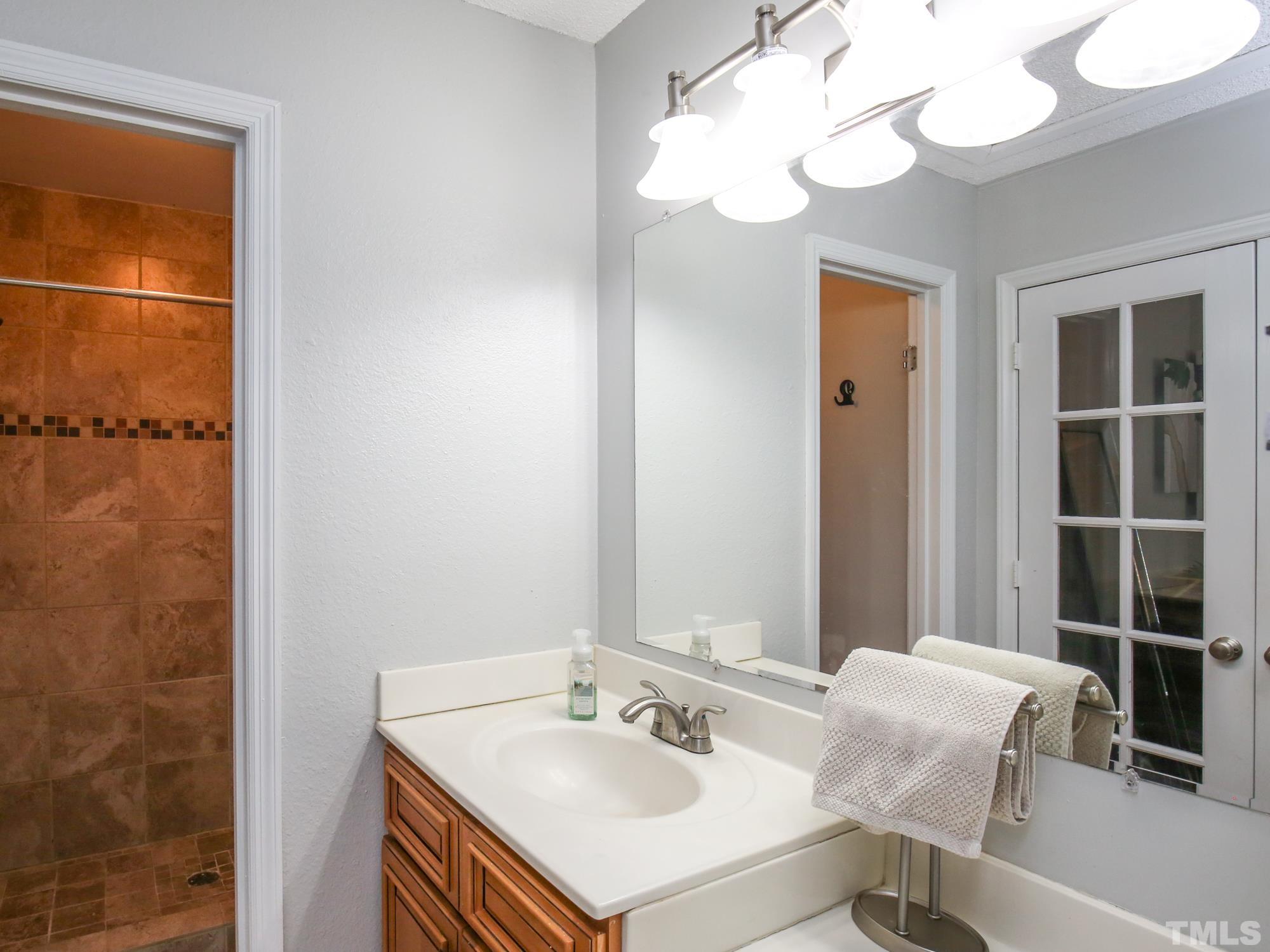 2429 Condor Court, Unit 2429 Raleigh, NC 27615 - Photo 18 of 26 a bathroom with a sink and a mirror
