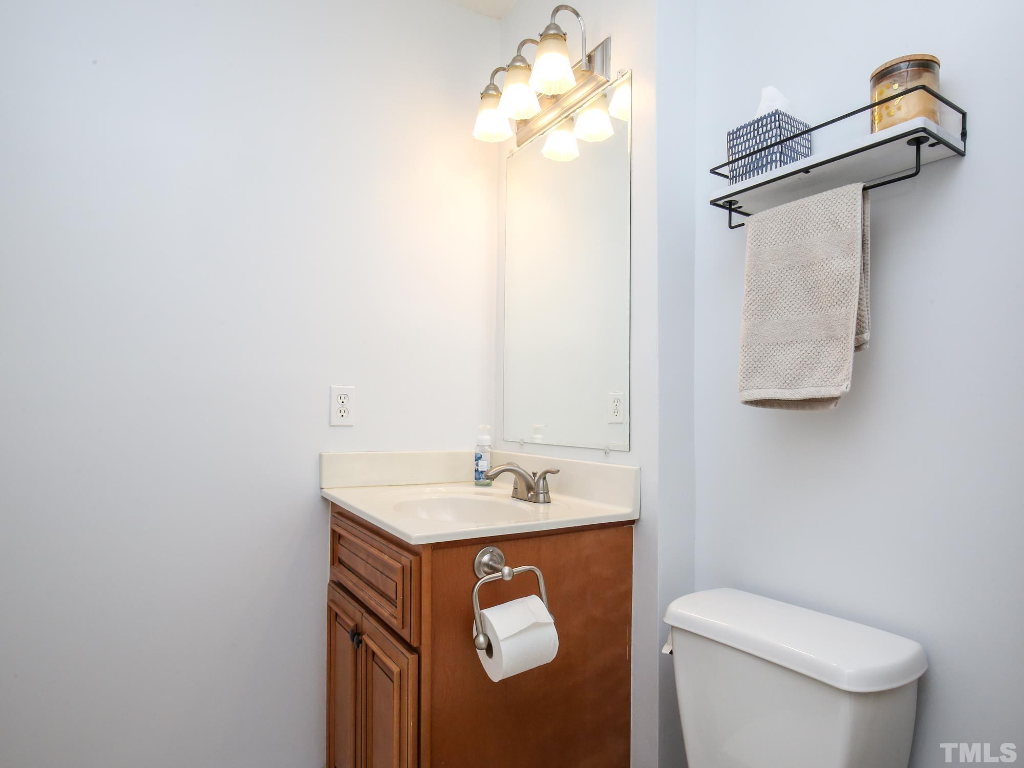 2429 Condor Court, Unit 2429 Raleigh, NC 27615 - Photo 23 of 26 a bathroom with a sink vanity mirror and toilet